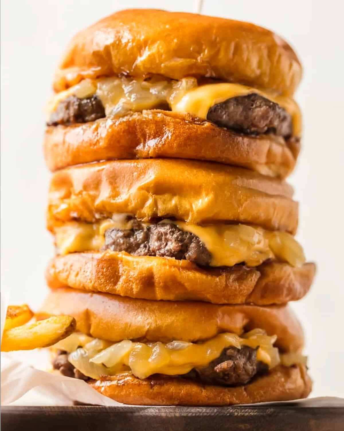 Butter Burgers are the most delicious burgers ever, cooked and smothered in butter! This Wisconsin Butter Burger recipe is everything your dreams are made of, juicy, cheesy, and absolutely tasty. stacked wisconsin butter burgers