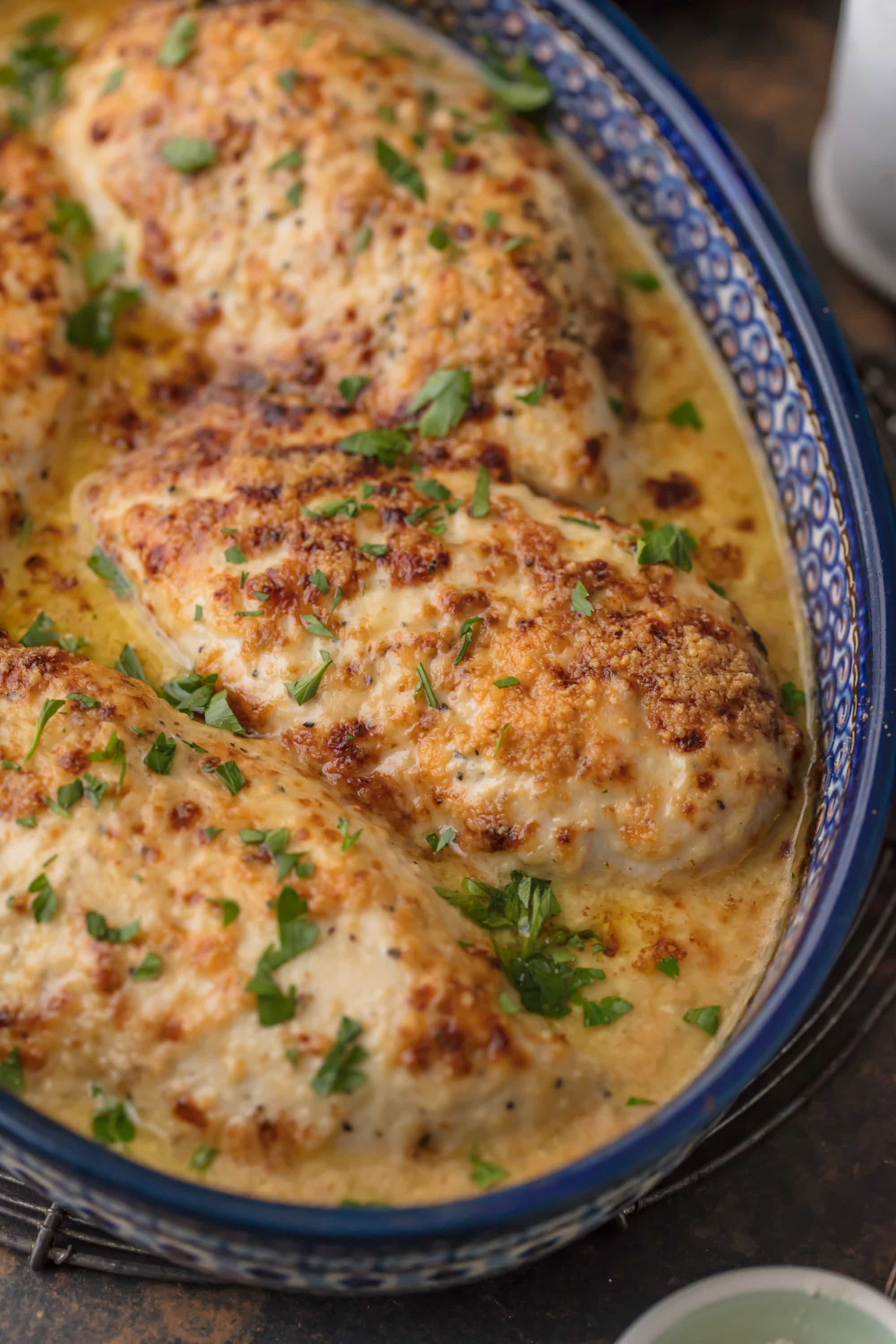 This Caesar Chicken Recipe (MELT IN YOUR MOUTH and only 4 Ingredients!) is made with only 3 ingredients (say WHAT?!) and is oh so tender and delicious. Easiest tastiest weeknight dinner ever. Made with just chicken, sour cream, creamy caesar, and grated parmesan. It will knock your socks off for both its flavor and how easy it is!